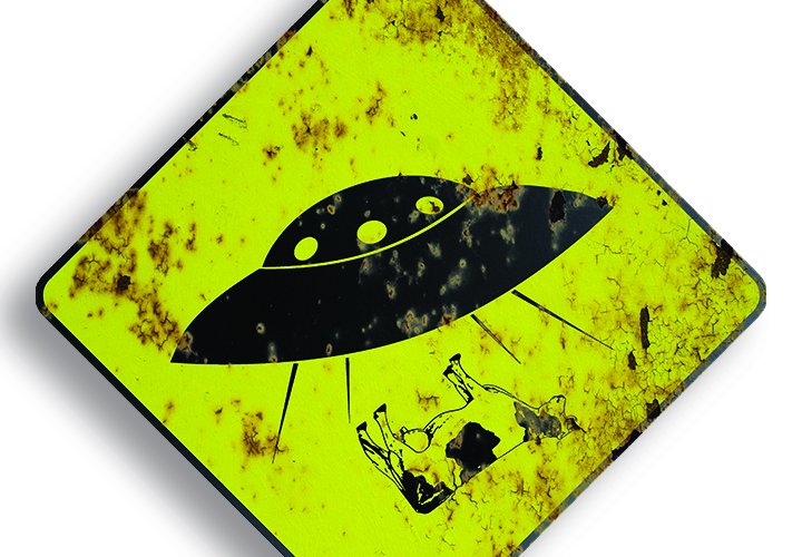 Rusted yeild sign cautions the possibility of alien abduction.
